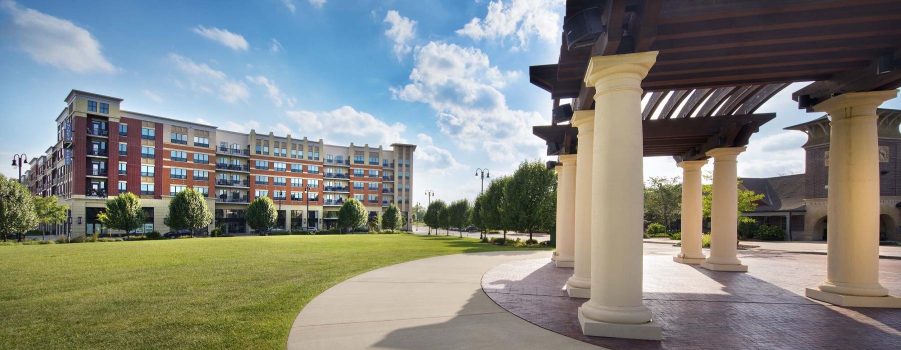 a building with pillars and grass