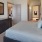 a bedroom with a bed and a mirror